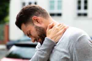 Man having neck pain at workplace