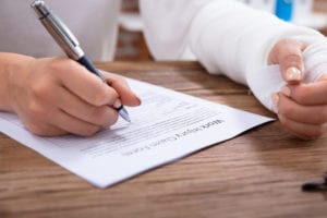 Man filling work injury claim form