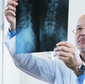 Doctor analysing X-ray