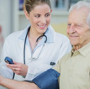 Doctor measuring old man blood pressure
