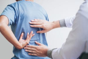 Doctor checking back pain issue
