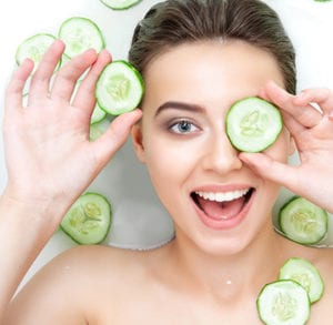 A woman with cucumber pieces