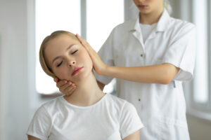 Chiropractor doing adjustment on female patients Neck