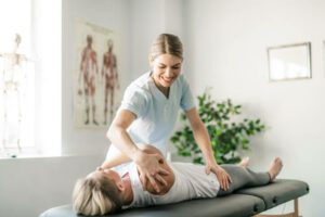 A Modern rehabilitation physiotherapy worker with woman clien