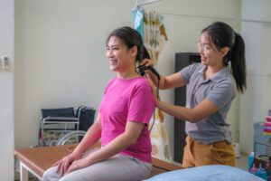 Asian woman patients having physical therapy ultrasound neck and shoulder muscles treatment with female doctor or physiotherapist on medical visit, Rehabilitation and Physiotherapy, Healthy lifestyle and Wellbeing, Alternative therapy and recovery