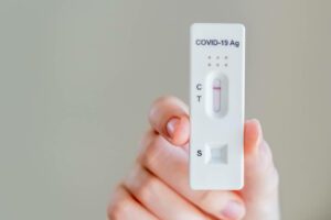 Hands holding Covid-19 rapid antigen test cassette with negative result of rapid diagnostic test