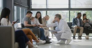 A family medicine physician speaks with a family that has a young child in the clinic's waiting room.