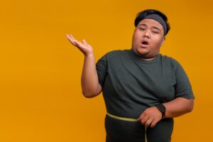 Surprised OverWeight Fat Man Measuring Waist with Tape.