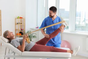 A Physiotherapist working with senior athlete during sports physical.
